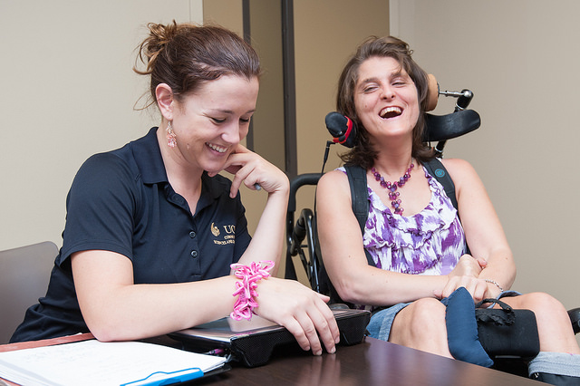 UCF student working with a clinic participant that is in a wheelchair