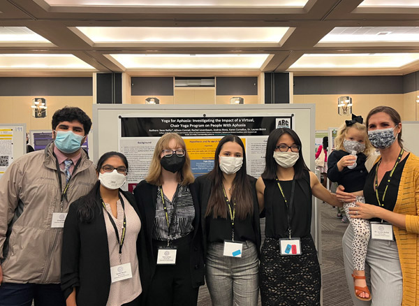 group shot of students standing in front of a research poster