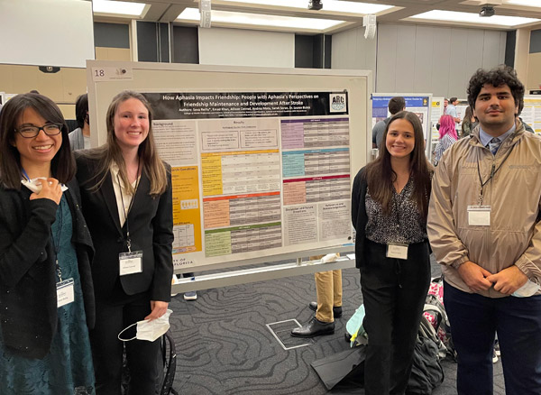 group shot of students standing in front of a research poster