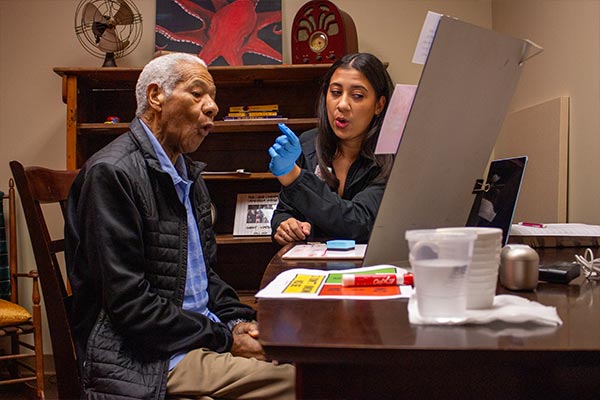 Student helping patient with speech