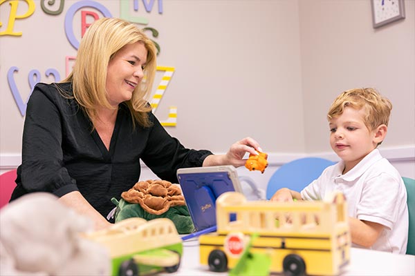 professor working with child and using toys