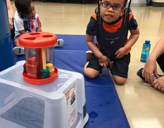 young boy using a harness system to be more active