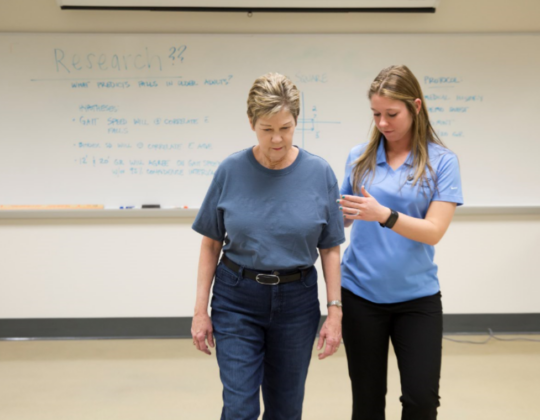 PT student helping elderly participant at the Innovative Mobility Initiative Lab