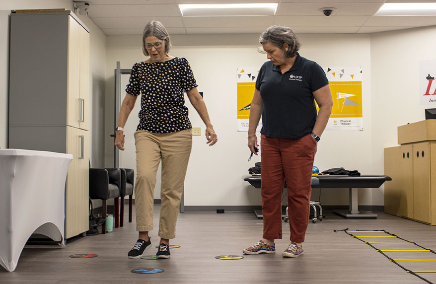 Physical therapy professor working with an elderly patient doing exercises