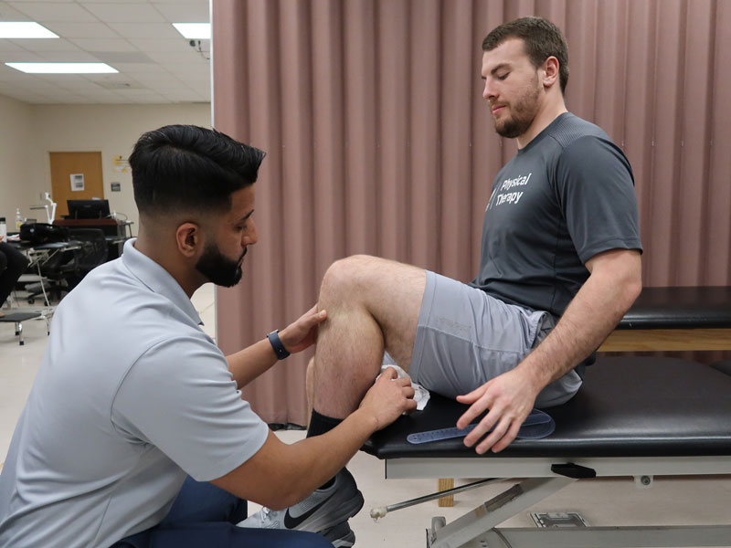 Students in the Musculoskeletal Research Laboratory taking a close look at the knee movement of another student