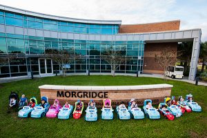 Retrofitted motorized toy cars in front of UCF’s Morgridge International Reading Center.