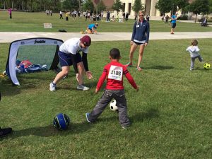 Children with physical and developmental disabilities at the Let’s Ignite! Activity Day on Memory Mall at UCF.