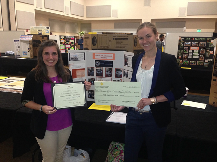 Hannah Pane and Maureen Gavin showing their Recognition of Excellence in the College of Health and Public Affairs.