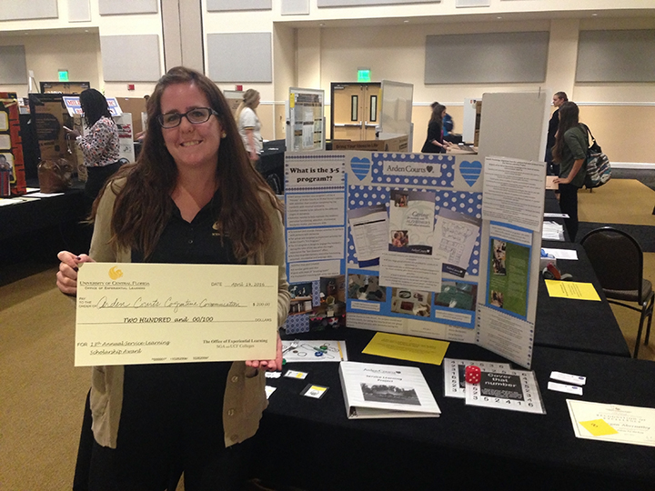 Amanda Shoff holding the Pedagogical Value Award.