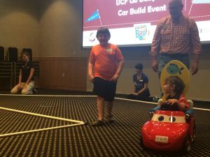 Children practicing on a "race course" inside FAIRWINDS Alumni Center.