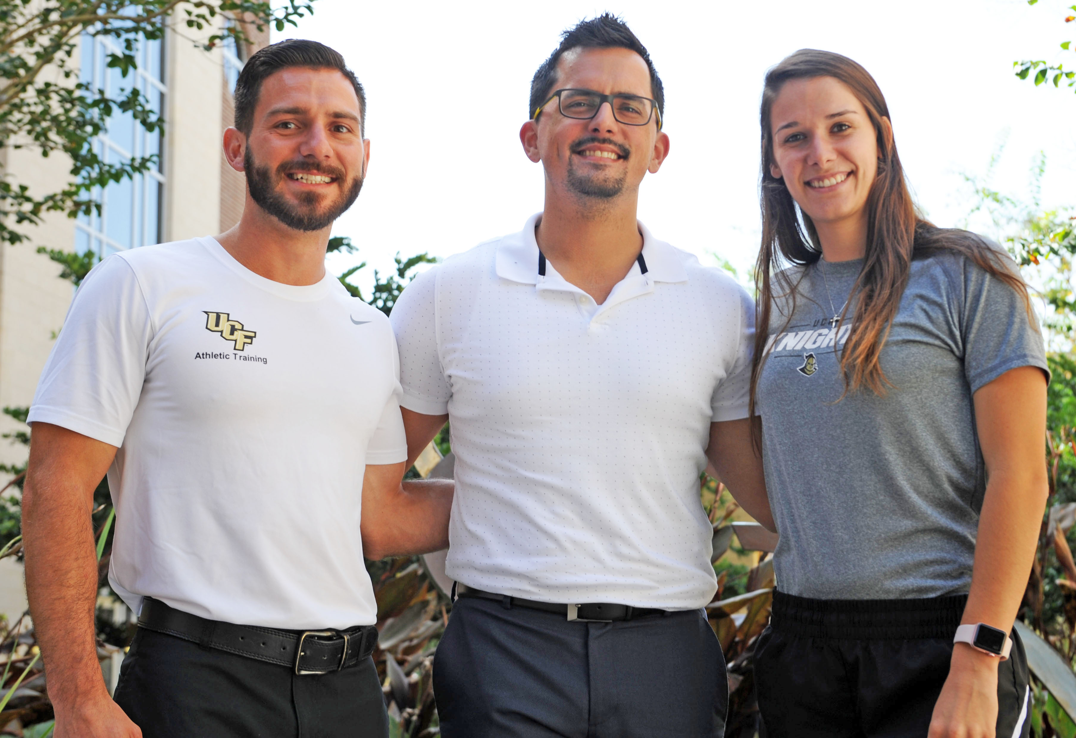 Carlos Gual stands with Blake DeSenti, left, and Alaina Locus, right, two athletic training students who participated in the interprofessional event