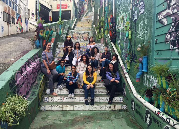 UCF graduate students and their faculty advisors sitting on a staircase in Bauru. 