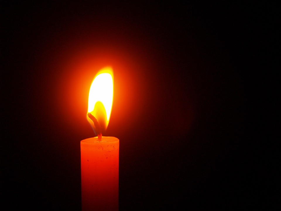 A candle lit in the dark.