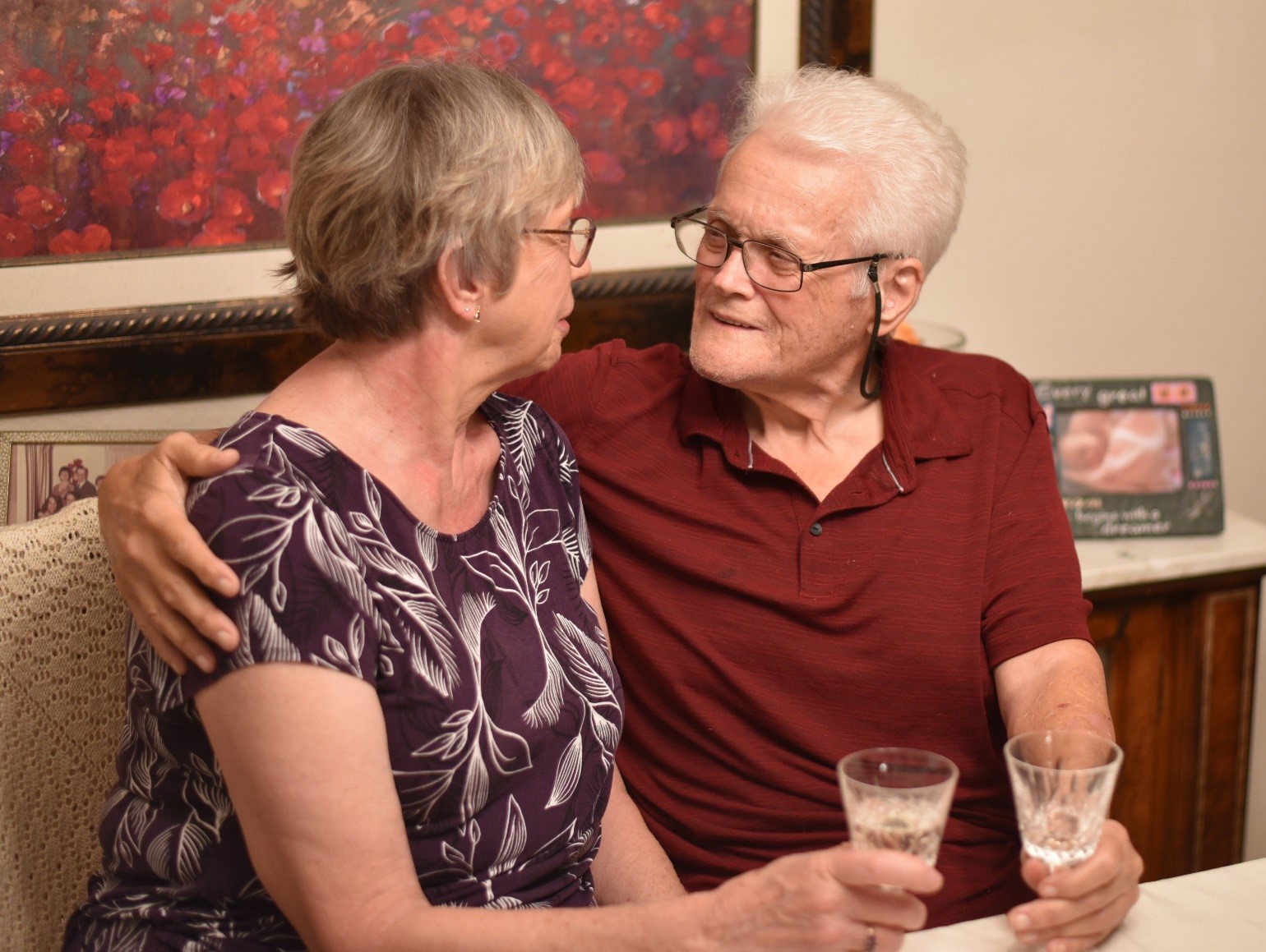 man hugs woman while sharing champagne