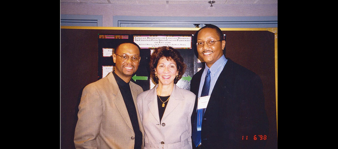 Kenyatta at a conference surrounded by colleagues