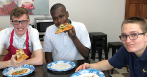 Kids enjoying pizza they made