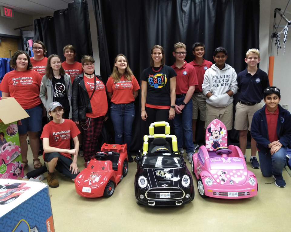 Group of students surrounding toy cars