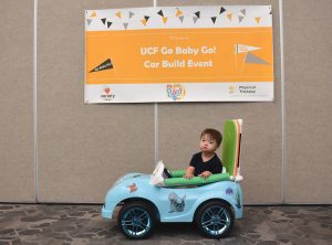 child in toy car