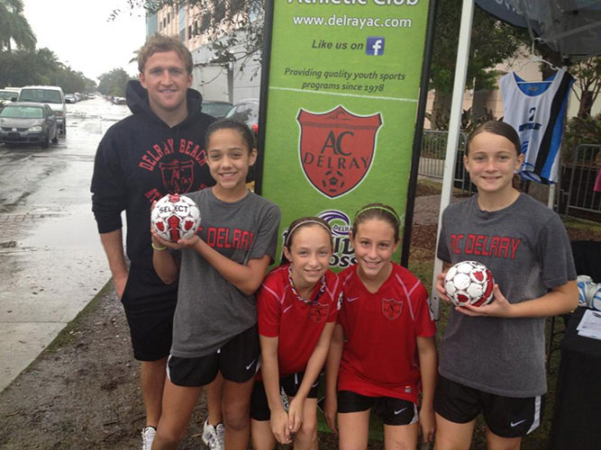 Brazendale and young girls in soccer outfits