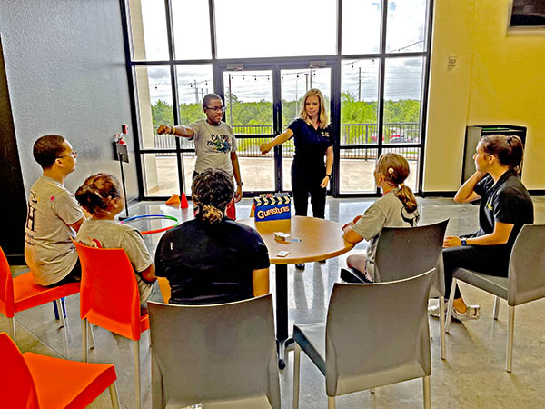 CSD clinician speaking to students sitting around a table