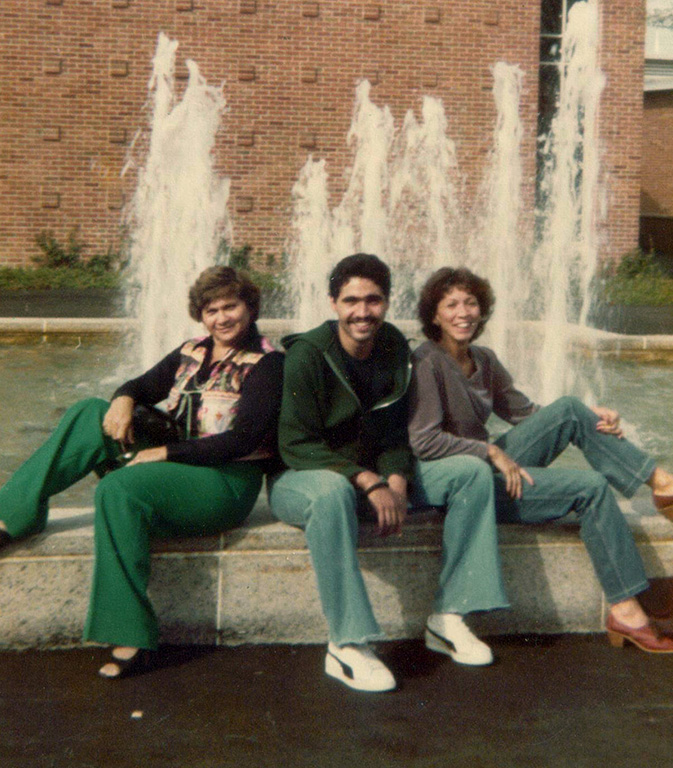 Linda I. Rosa-Lugo's mother, Iris Lugo (at left), Bernardo and Linda sitting in front of a fountain.