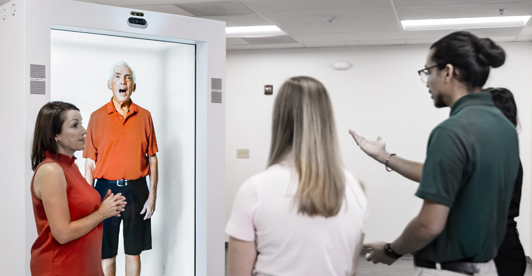 People standing in front of Hologram machine.