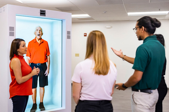 students standing in front of a hologram