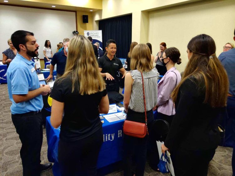 Man speaking to students at a career fair