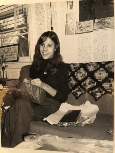 Sophia Dziegielewski as a student sits on a couch.