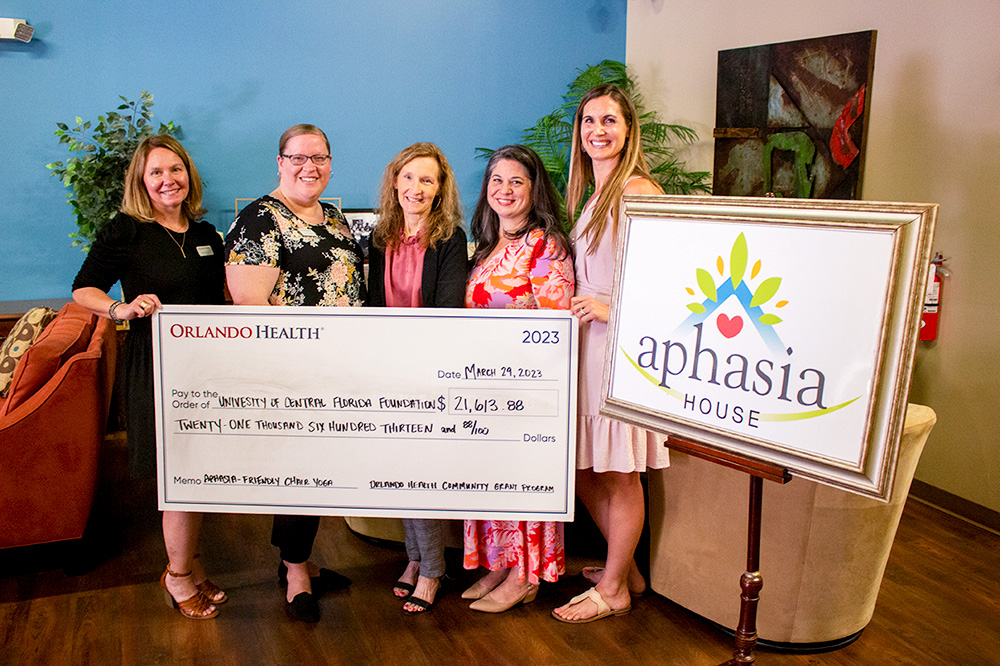 5 women holding an award check