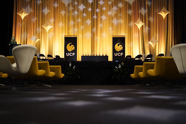 Ballroom with UCF banners on each side and awards on a table in the middle.