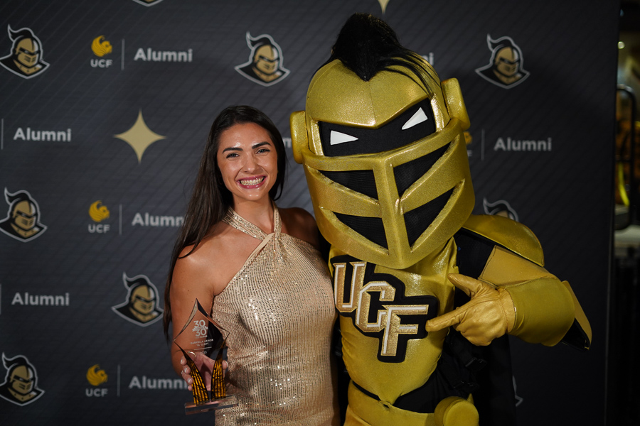 Gabriella Armor standing with Nitro, UCF Knight mascot.