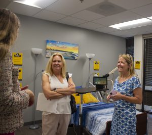 Two women talking to Carolyn Buchanan in the smart apartment