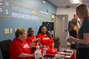 AARP representatives talking to a fair attendee