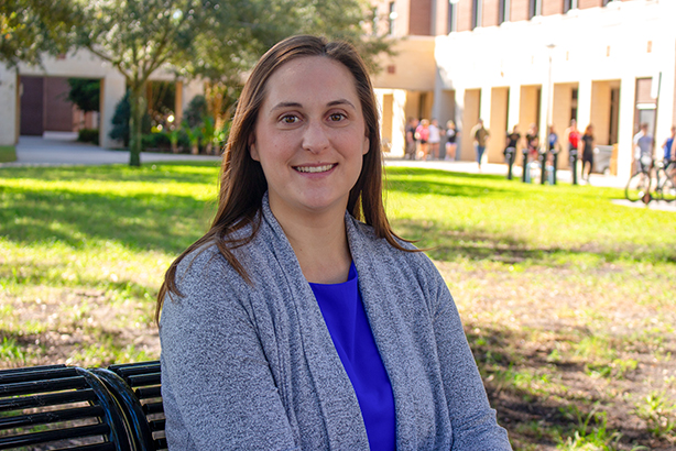 Meredith Chaput, a physical therapy assistant professor, seated outside the Health Sciences buildings.