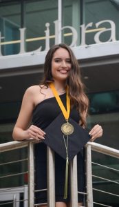 Sydney Martinez holding graduation cap