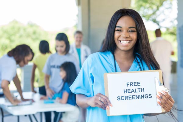 student holding sign for free screenings