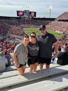 Mason Moore with his wife and daughter at a UCF football game.