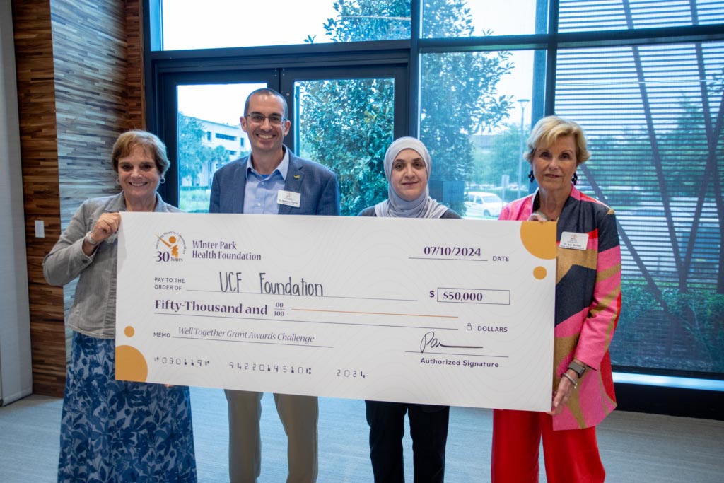 People holding an oversized $50,000 check