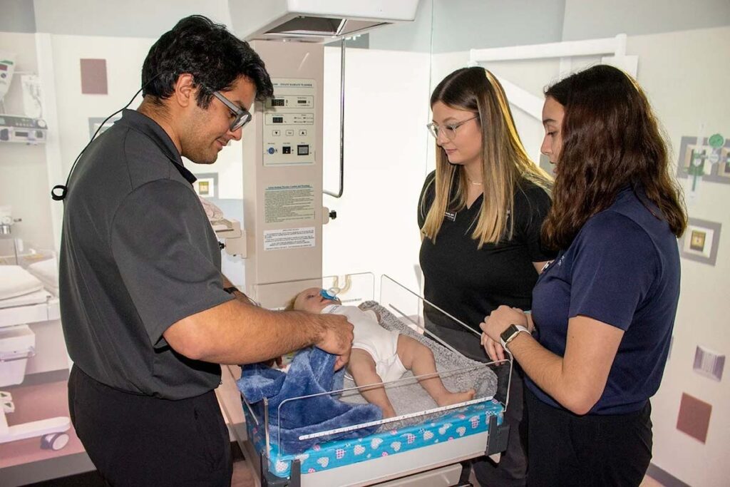 UCF College of Health Professions and Sciences students working in the simulated neonatal care unit in the college’s Blended Learning Interactive Simulation Suite.