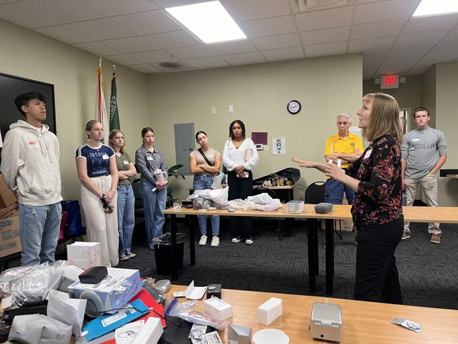 Dr. Janel Cosby explains to her students how to distinguish between usable and unusable hearing aids at the Seminole County Sheriff’s Office East Region on Saturday. She carefully pointed out the key features that help determine whether a device can be refurbished or should be discarded.