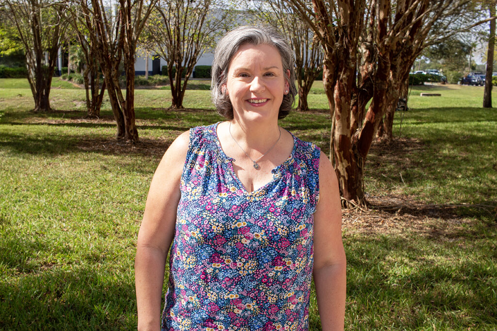 Photo of Nicole Dawson standing outside in front of a group of trees