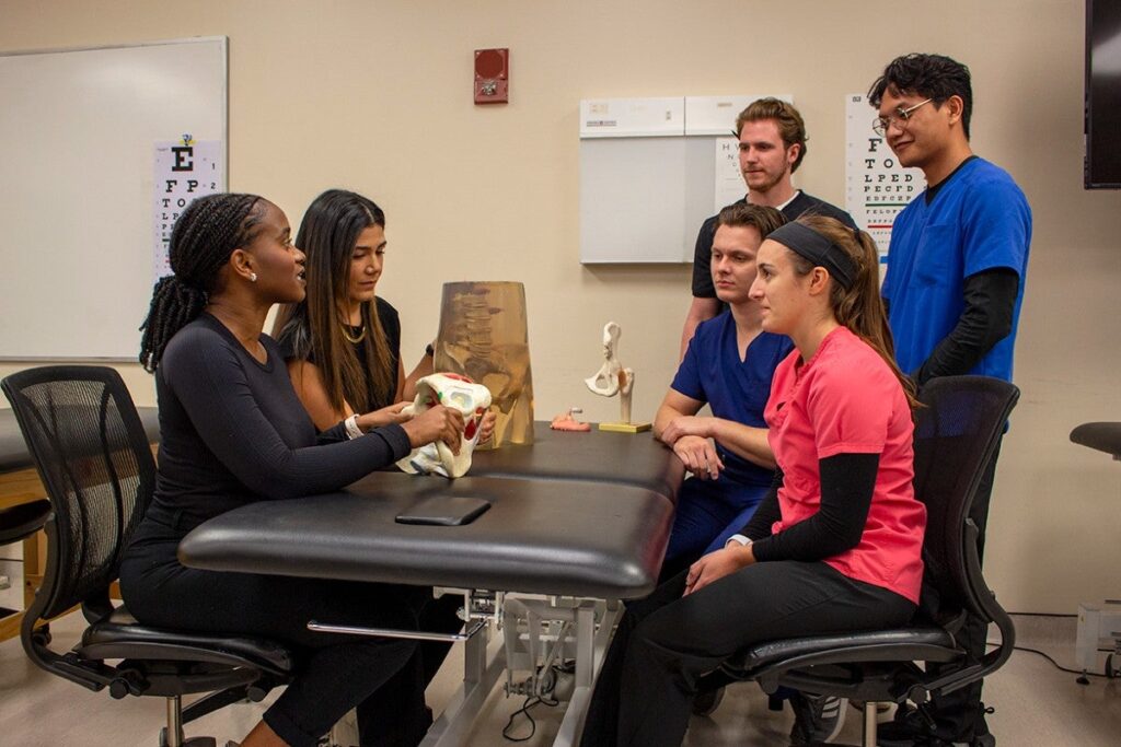 Melinda Honore and Laura Arboleda ’13, two residents in the new women’s health residency program from UCF and Orlando Health, work with doctoral students from UCF’s physical therapy program.