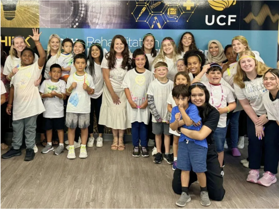 iREAD Director Carrie Loughran in a group photo with students from the program.