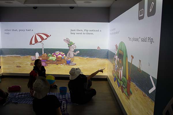 Student clinicians help children improve their reading and literacy skills inside the Blended Learning Interactive Simulation Suite.