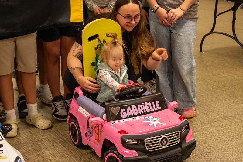 Physical therapy students assist children with mobility needs through UCF Go Baby Go!