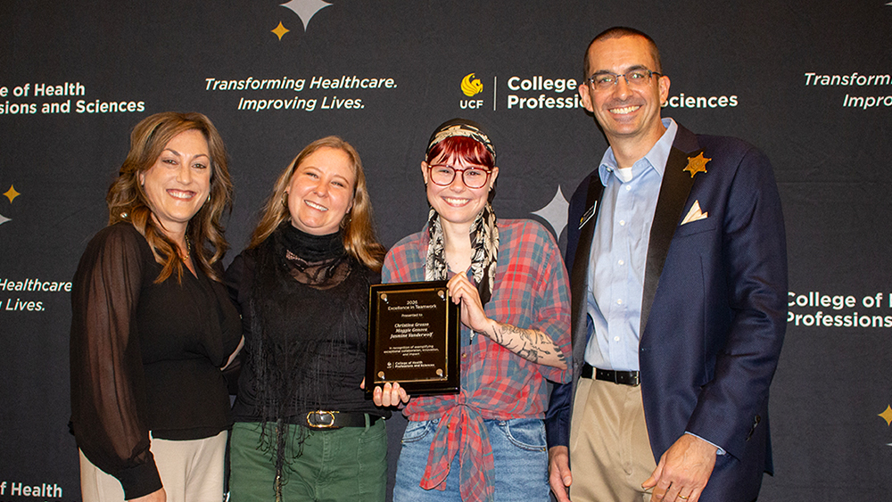 Bari Hoffman, Christina Grosso, Maggie Genova, and Matthew Theriot smiling in front of a CHPS backdrop with Maggie holding an award